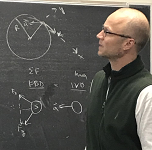 Duff Harrold, AATC Physics and Math Specialist standing at a chalkboard.