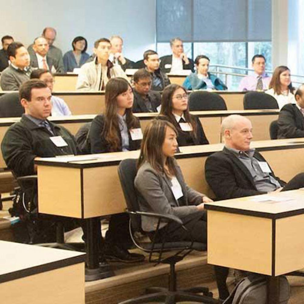 Students in a classroom listening to a speaker