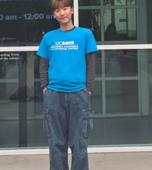 Man in blue shirt in front of Library