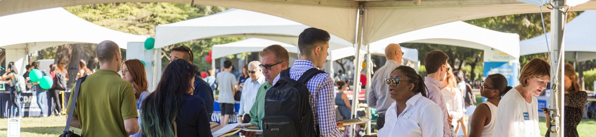 Students interacting with recruiters at the Grad and Law School Fair