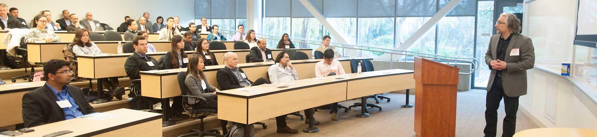 Students in a classroom listening to a speaker