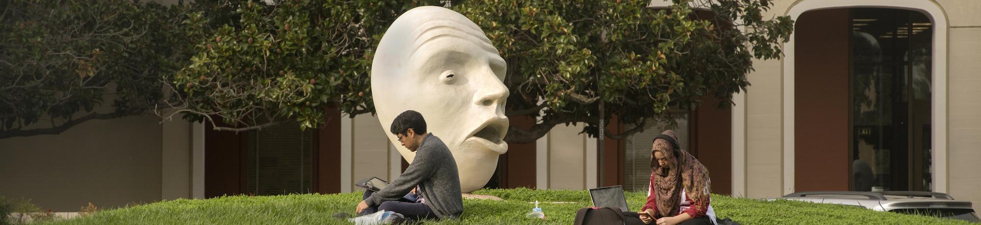 Student sitting near the Mrak Hall egghead